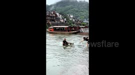 Heroic elderly man dives into river to rescue drowning tourist in China