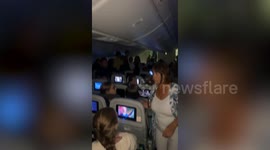 Plane passenger tries to open cabin doors mid-flight