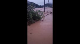 The Hero excavator driver risks his life driving the excavator into floodwaters to clear the flow and prevent floodwaters from damaging the dike