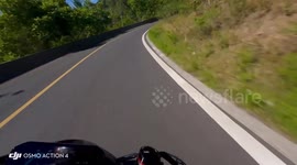 Motorcyclist falls into roadside hole and sits beside bike in Shandong, China