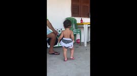 Toddler shows off dance moves in front of speaker in Aracati, Brazil