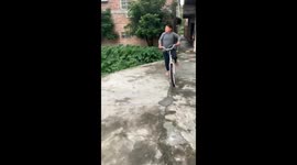Boy loses control of bicycle and falls into canal in Guangdong, China