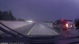 Sudden lightning bolt illuminates highway during storm in Guelph, Ontario