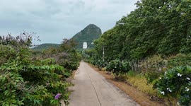 A beautiful temple and large Buddha statue on a mountainside in Lopburi, Thailand.