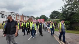 A young couple in a car wanting to drive out before the Stand Up To Racism protest in Epping goes past gets into trouble with the police