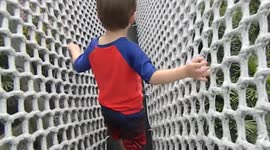 Crossing a giant rope bridge high in the sky in a theme park