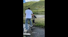 Funny father and son bonding moment during water crossing in Jiangsu, China