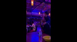 When karaoke is life! Drinker calmly carries on singing as fight erupts at bar