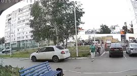 Woman sprinting across street knocked down by boy on e-scooter