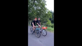 Two cyclists fall after riding in sync in Jakarta, Indonesia