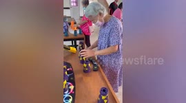 Nursing home teaches pensioner Speed Stacks game to help improve brain function
