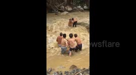 Heroic villagers brave raging floodwater to rescue stranded boy in China