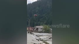 Helicopter extracts stranded residents from homes during deadly floods in Romania