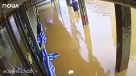 Floodwaters enter phone shop after heavy rain in Myanmar