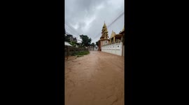 Locals wade through flash floods caused by heavy rains in Myanmar