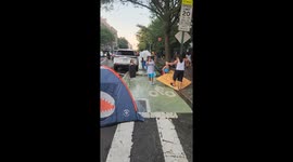 Kids float through DIY street water park in Manhattan, New York