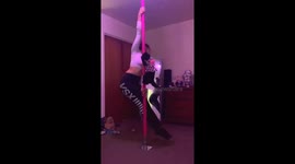 Cat poses on pole, she shows off her pink dress pole dancing with her owner as she shoulda on to the spinning pole !
