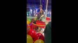 Joyful moment in human claw machine at Dave & Buster’s in Schaumburg, Illinois, USA