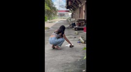 Tourist startled as she tries to stroke a stray cat