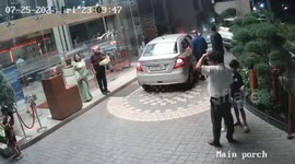 Bungling driver reverses car through hotel lobby glass front