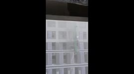 Construction cradle torn off by strong winds slams into building