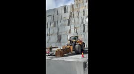 Up close footage shows huge granite slab being toppled over at Norwegian quarry