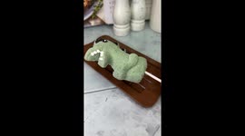 Melting a cute green marshmallow dragon into a chocolate mold using a hair dryer.