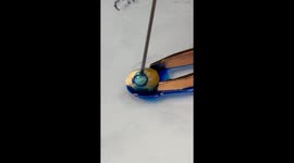 Blue dye injected into single popcorn kernel and heated up using hair straighteners