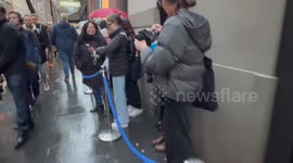 Long queue of people line up in the rain just before 5pm for Prime Book Club LIVE