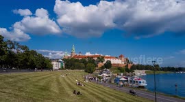 Time lapse of Wawel castle and Visla Vistula river with tourist boats in Krakow, Poland