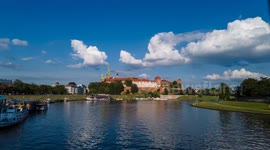 Time lapse of Wawel castle and Visla Vistula river with tourist boats in Krakow, Poland