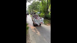 Toddlers float in makeshift pool inside cargo bed of mini truck