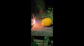 Sparkler successfully passes through an orange and glows brightly at the end