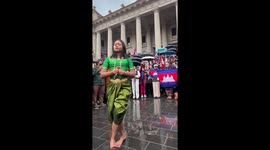 Cambodian woman performs traditional dance at rally in Australia