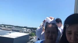 Residents take shelter on rooftoop after tsunami alert in Japan