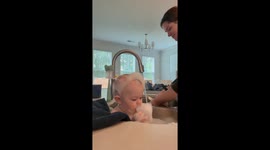 Little boy quietly plays with bubbles while sitting on sink in Greenville, South Carolina, USA