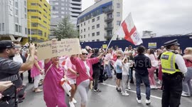 Anti Migrant Protesters perform a conga outside the Britannia International Hotel in Canary Wharf