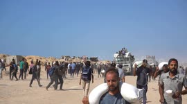Gazans gather near Zikim crossing to access limited aid