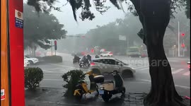 Man knocked off scooter by flying sheet of metal as severe storm hits Chinese city