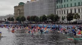 Thousands of paddle boarders wear fancy dress for festival in Russia