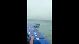 Tourists cling to pontoon after getting caught in rough sea in Thailand