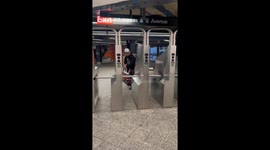 Man fails to clear subway turnstile and falls in New York City, New York, USA
