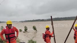 Officials brave raging river currents, pull off daring rescue of three stranded lives from torrential waters