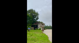 House collapses into river as heavy rain causes banks to weaken