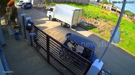 Kind deliveryman carefully carries parcel through gate bars