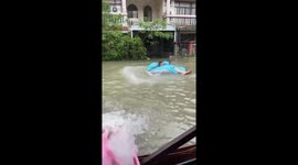Local splashes on inflatable sofa on flooded road