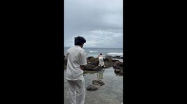 Boyfriend slips into sea while taking beach photo of fiancee