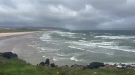 Strong coastal winds sweep the dunes in Portstewart, Ireland