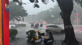 Metal sheet blown from roof hits motorcycle riders at junction