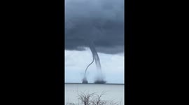 Twin waterspout tornadoes intersect off the coast of Italy